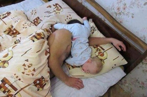 Dad sleeping with his baby