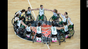 wheelchair basketball team huddles and celebrates their victory ...