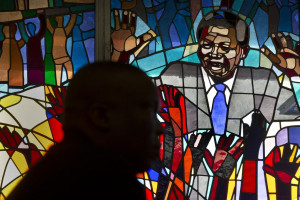 in front of a stained-glass window of Nelson Mandela at a morning ...