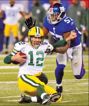 Green Bay Packers quarterback Aaron Rodgers is tackled by New York ...