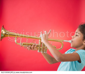 mixed race girl playing trumpet