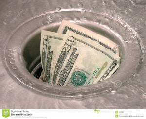 Money in a garbage disposal with the water running.