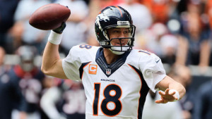 Peyton Manning #18 of the Denver Broncos drops back to pass during the ...