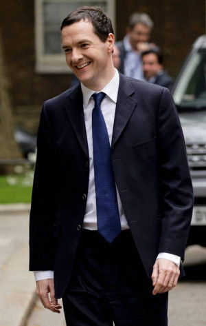 the Exchequer George Osborne smiles as he returns to number 11 Downing