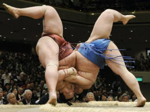 Sumo wrestlers Tosayutaka, right, and Toyohibiki fall to the ground ...