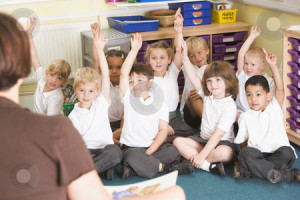 ... their hand in a primary class stock photo, by Monkey Business Images