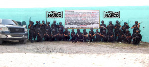 ... cartel pose next to a narco banner (all pictures credit to BDN