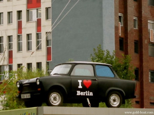 Old East German “Trabi” Near the Remnants of the Berlin Wall