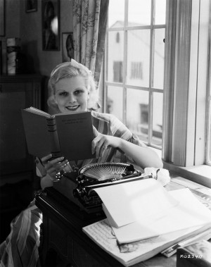 Actress Jean Harlow (1911-1937) studies the novel ‘Red Headed Woman ...