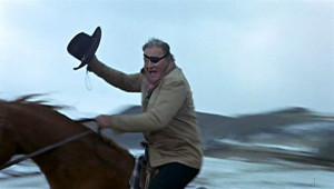 The meanest is Rooster Cogburn. He is a pitiless man, double tough ...