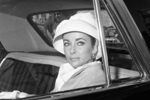 Elizabeth Taylor in close up picture as she sits in the back sear of a ...
