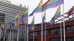 ... Putin's visit by flying gay pride flags on all city council buildings