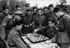 ... of the Wehrmacht, play chess in this staged photo. Normandy, 1943