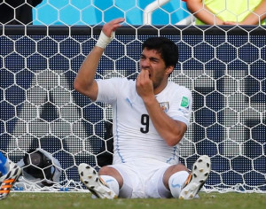 Uruguay's Luis Suarez holds his teeth during the 2014 World Cup Group ...