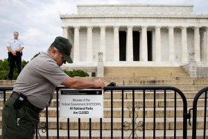 US Park Police officer watches at left as a National Park Service ...