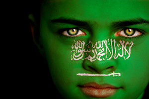 Portrait of a boy with the flag of Saudi Arabia painted on his face