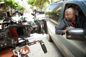 Andy Samberg (L) and Andre Braugher (R) bust guest star Michael Grant ...