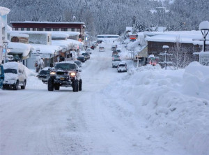 ... move down snow-covered streets in the fishing town of Cordova, Alaska