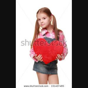Lovely little girl with funny hair style of the two tails is holding a ...