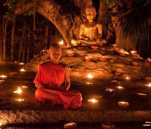 Beautifully Meditating Little Monk Before Lord Buddha in Night Lamp