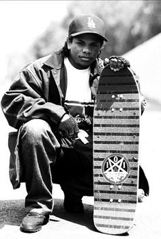Eazy-E poses with a Natas Kaupas “Devil Worship” model skateboard ...