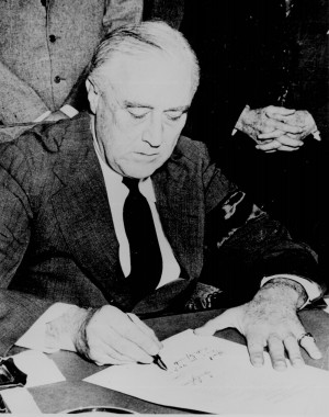 president franklin d roosevelt signing the declaration of war against ...