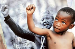 ... boy immitating a picture Nelson Mandela's raised fist during a speach
