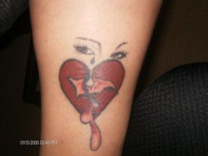 crying eyes with bleeding and broken heart tattooed on forearm