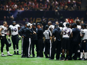 Head coach John Harbaugh (C) of the Baltimore Ravens talks with ...