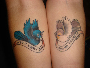 ... symmetrical arm tattoos. Meaningful text banners complete the design