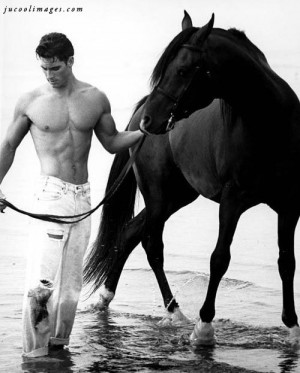 Stunning guy with horse on beach