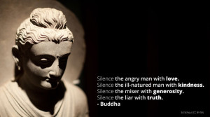 Buddha statue with quote on silencing anger, greed, etc