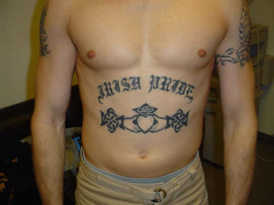 Large Old English Letter Style Name On Back Tattoo