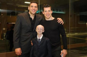 Bruins Milan Lucic (left) and Andrew Ference with Sam.