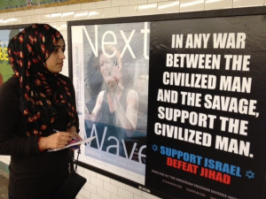 Subway rider Javerea Khan reads anti-Jihad poster at the Times Square ...