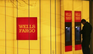 man uses an automated teller machine (ATM) at a Wells Fargo Bank ...