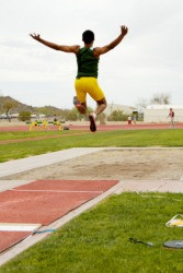 An competitor performing the broad jump or long jump.