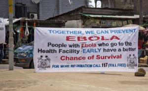 banner encouraging people suffering from Ebola to go immediately to ...