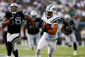 Lamarr Woodley Eric Decker 87 of the New York Jets runs after a catch