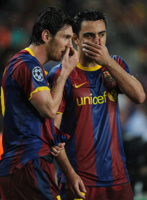 Xavi Hernandez Lionel Messi (L) of Barcelona lines up a free kick with ...