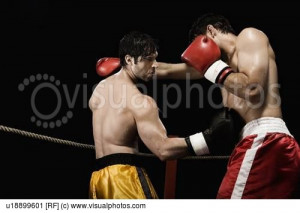 Boxers fighting in boxing ring