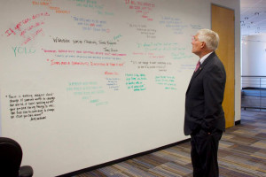 Congressman Pete Sessions observing the quote wall at the DEC