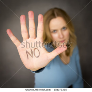 blond woman expressing denial with NO on her hand - stock photo