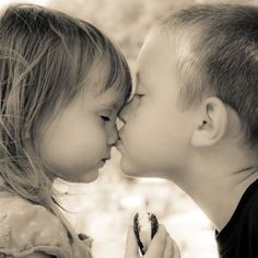 Little boy kissing little girl on the nose... and he means it. But she ...