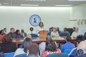 Sybil Wilkes addresses the audience while the scholarship recipients ...