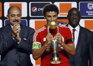 Egypt's Al Ahli's team captain Hossem el Sayed kisses a trophy after ...