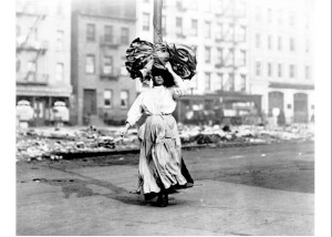 An Italian immigrant woman in New York carries a bundle of clothing ...