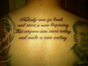 wonderful upper back quote tattoo with portraits
