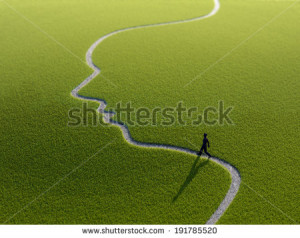 lonely person walking along a face-shaped path - stock photo