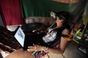 Brazilian native Indian Zahy Guajajara checks her computer in the ...